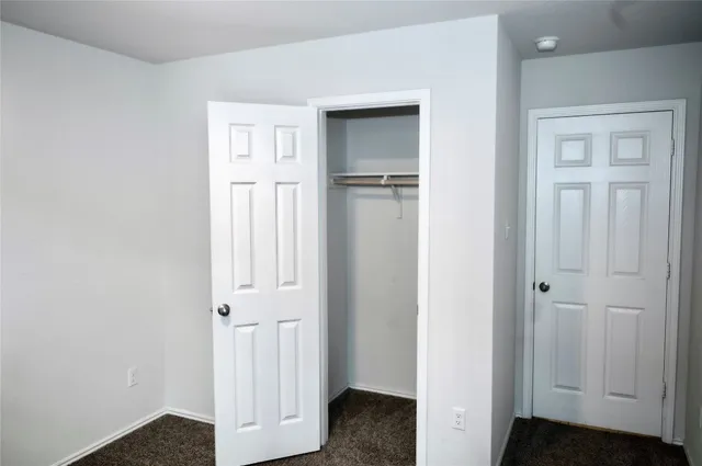 an entryway to room with wooden floor