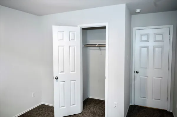 an entryway to room with wooden floor