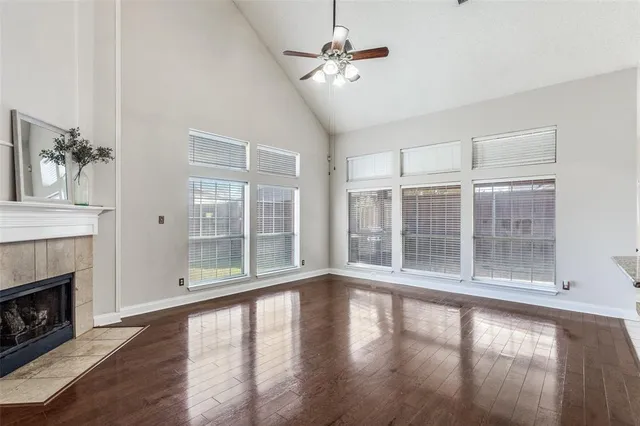 a view of empty room with wooden floor and fireplace