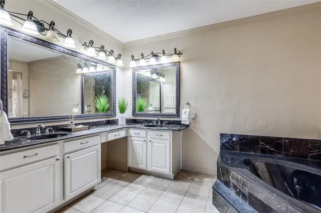 a bathroom with a tub shower and sink