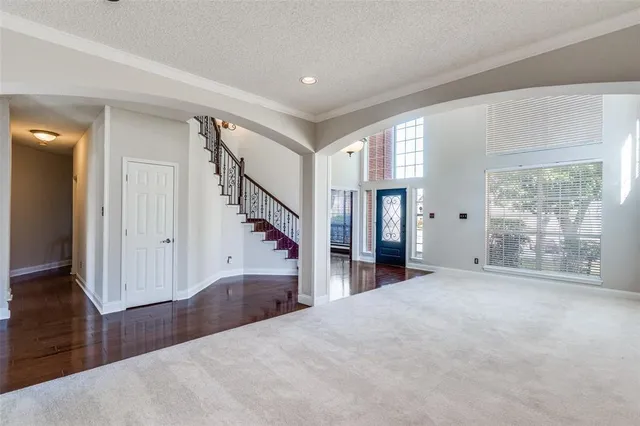 a view of a livingroom with wooden floor and stairs