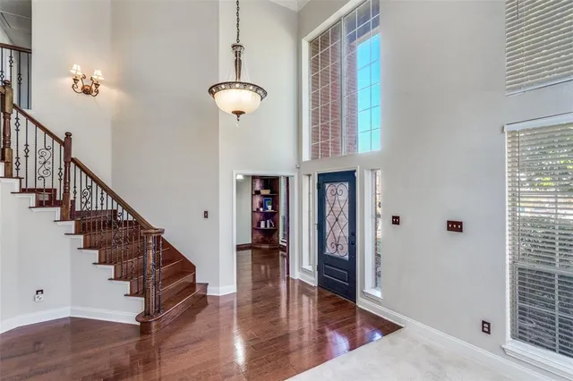 a view of entryway and hall with wooden floor