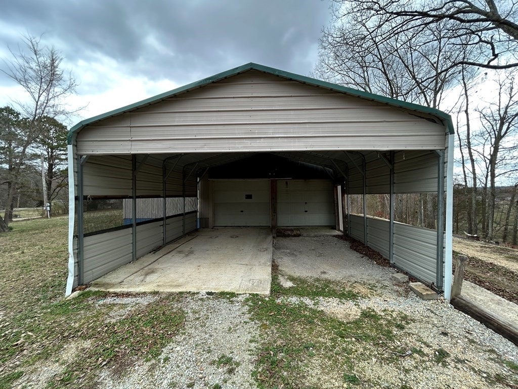 130 Clement Street Big Sandy, TN 38221 - Photo 3 of 17 front view of a house with a yard and garage