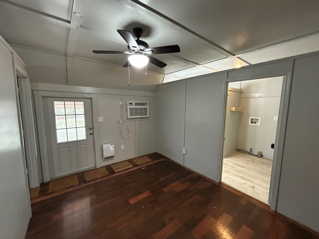 130 Clement Street Big Sandy, TN 38221 - Photo 4 of 17 a view of empty room with wooden floor and fan