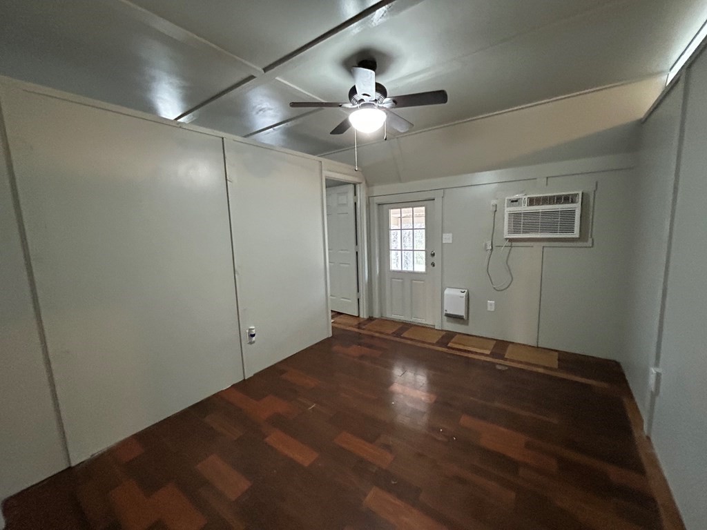 130 Clement Street Big Sandy, TN 38221 - Photo 5 of 17 an empty room with window and ceiling fan