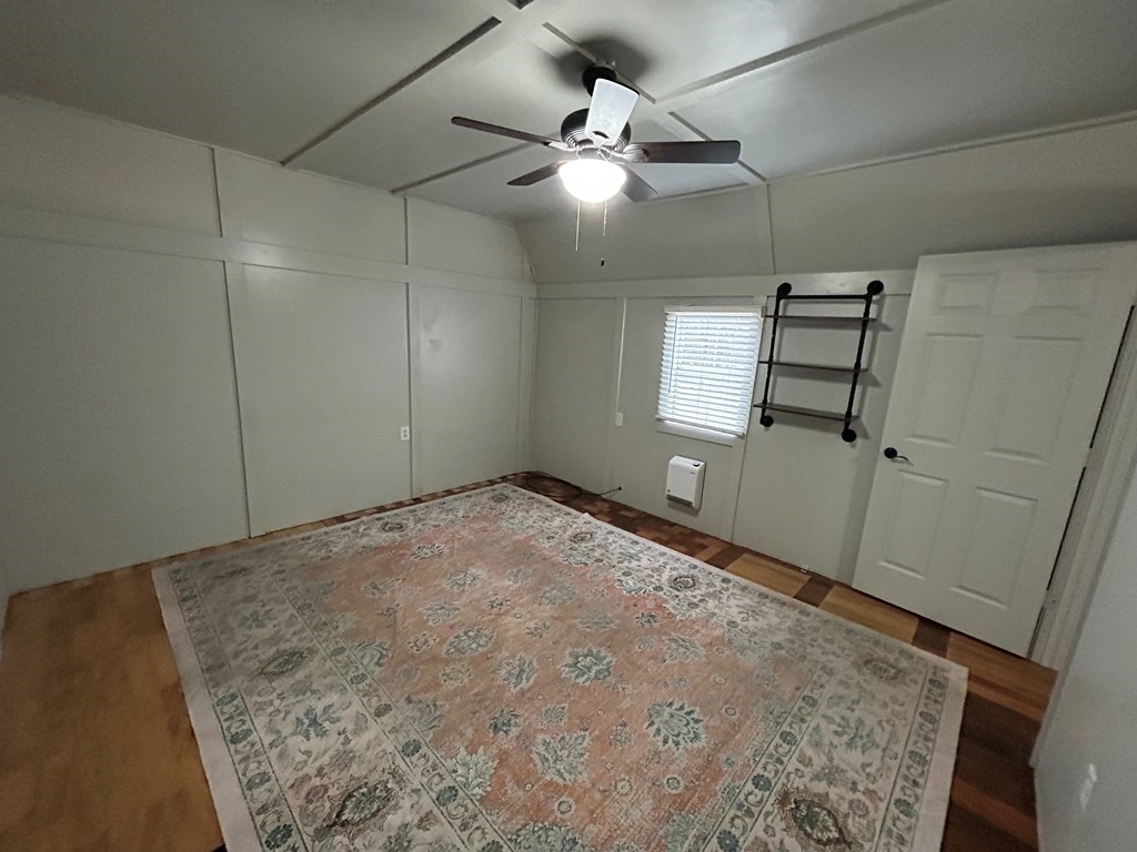 130 Clement Street Big Sandy, TN 38221 - Photo 8 of 17 an empty room with windows and fan