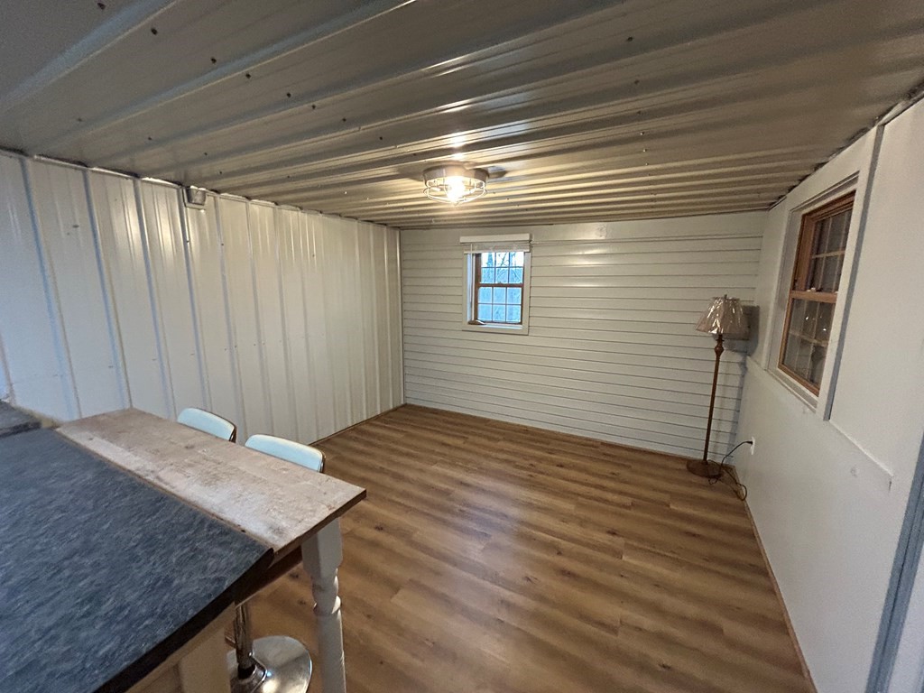 130 Clement Street Big Sandy, TN 38221 - Photo 9 of 17 a view of kitchen island wooden floor and staircase