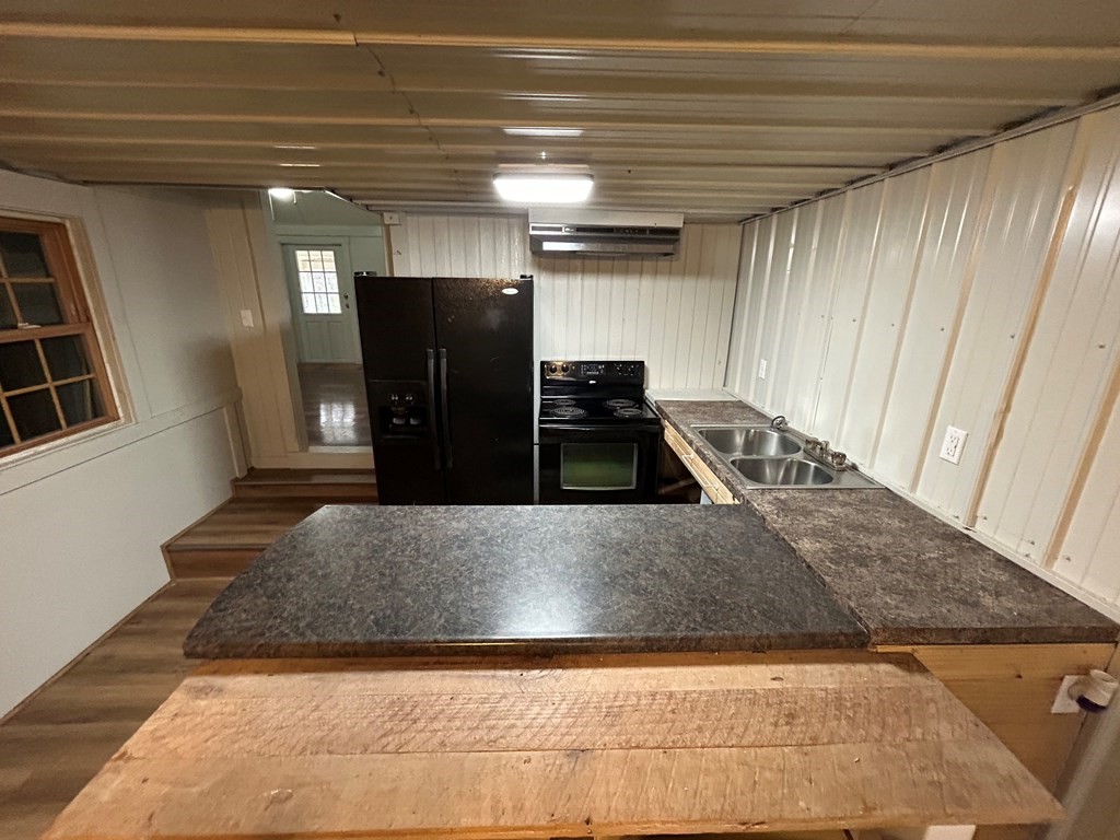 130 Clement Street Big Sandy, TN 38221 - Photo 10 of 17 a kitchen with refrigerator and window