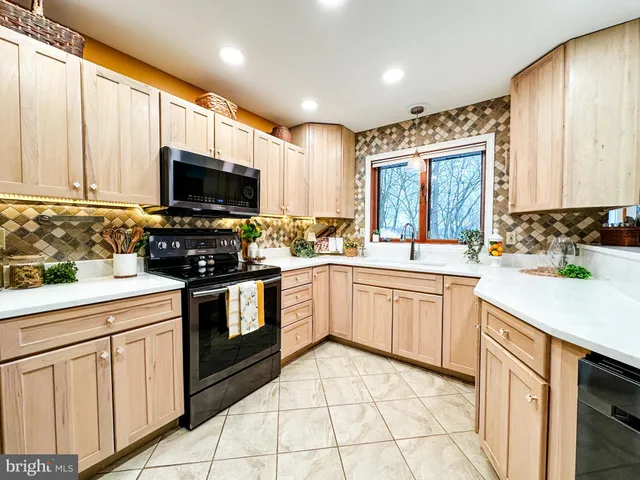 a kitchen with a sink stove and microwave