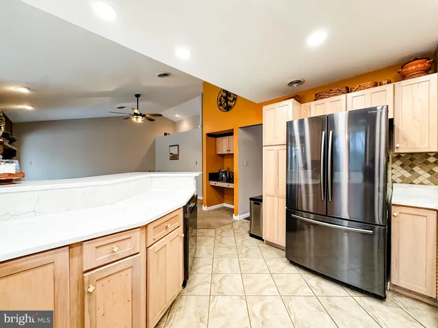 a kitchen with stainless steel appliances a refrigerator and a stove top oven