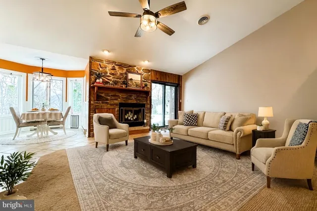 a living room with furniture a fireplace and a flat screen tv