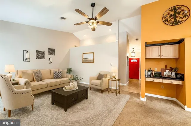 a living room with furniture and a chandelier