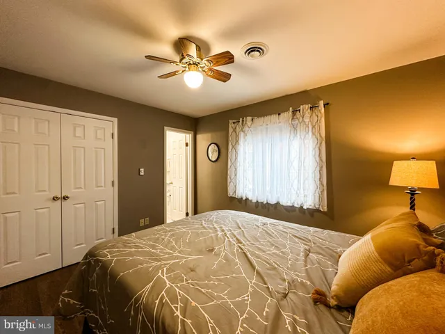 a bedroom with a bed and a lamp