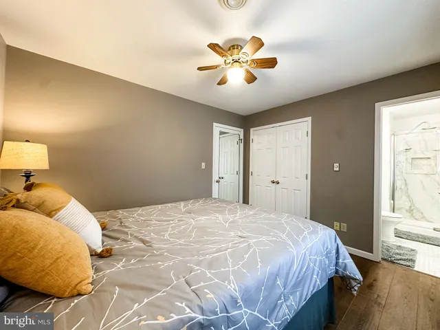 a bedroom with a large bed and a chandelier
