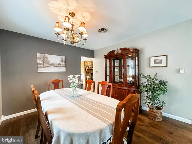 a view of a dining room with furniture wooden floor and chandelier