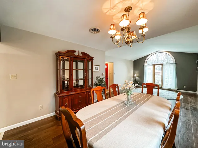 a bedroom with a bed mirror and a chandelier