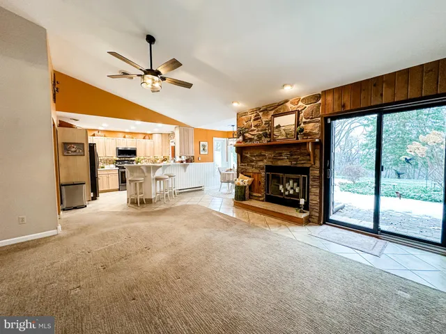 a view of empty room with fireplace and fan
