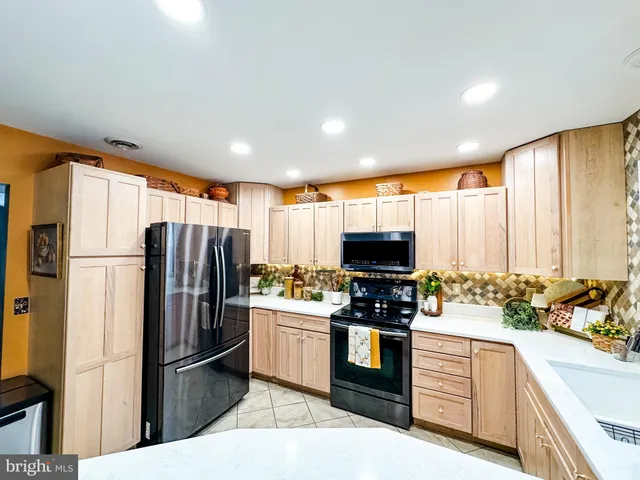 a kitchen with stainless steel appliances a refrigerator stove and microwave