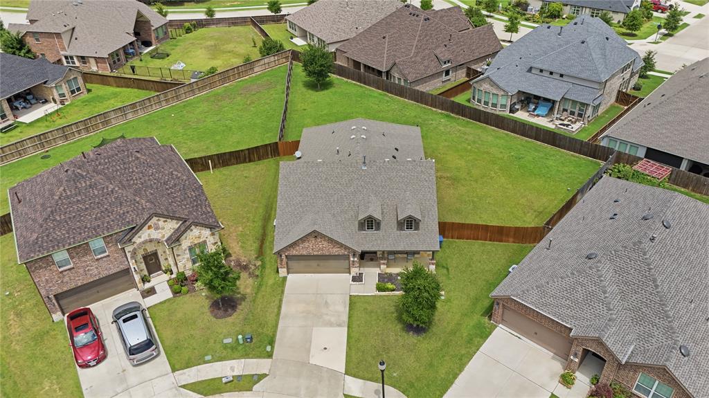 10101 Travis Road Little Elm, TX 75068 - Photo 3 of 26 an aerial view of a house with a garden and a car park