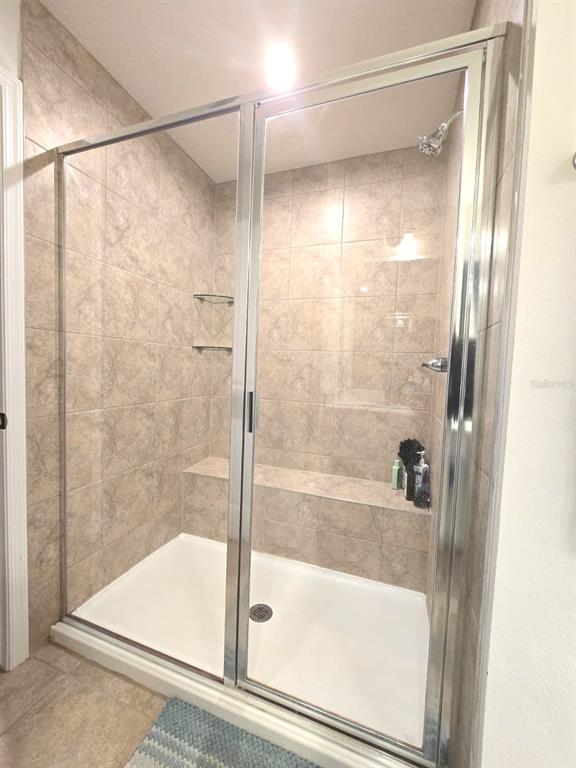 10682 Old Sycamore Loop Land O Lakes, FL 34638 - Photo 13 of 22 a bathroom with a glass shower door