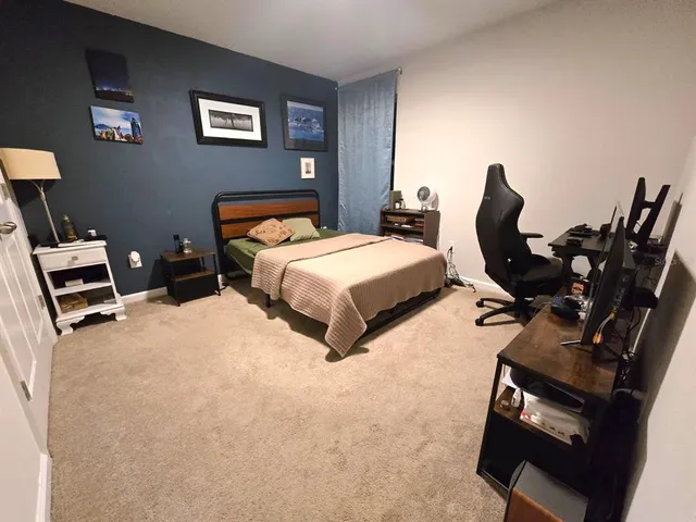 a bedroom with bed and window