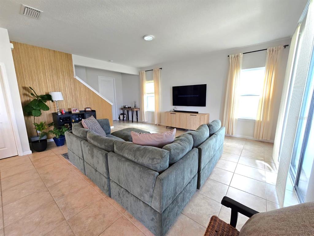 10682 Old Sycamore Loop Land O Lakes, FL 34638 - Photo 8 of 22 a living room with furniture and a flat screen tv