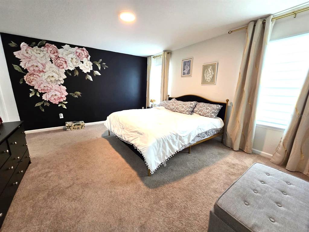 10682 Old Sycamore Loop Land O Lakes, FL 34638 - Photo 10 of 22 a bedroom with a large bed and a window