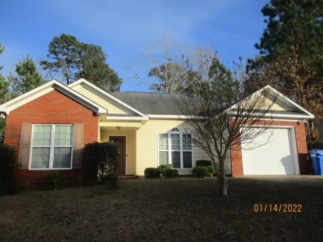 a view of house with yard