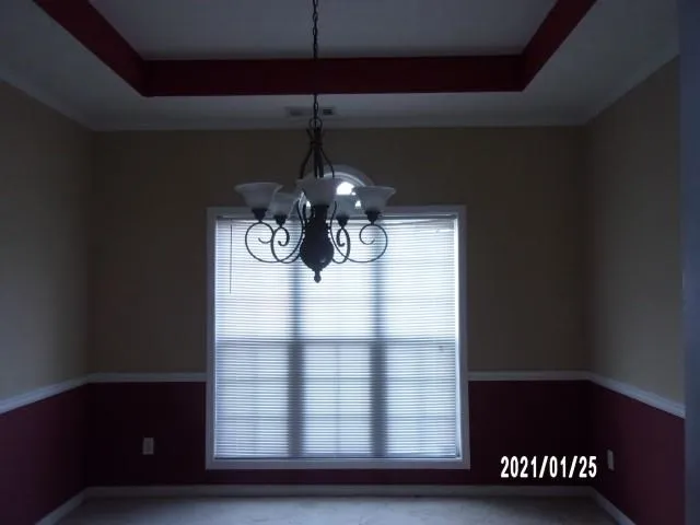 a glass vase sitting on a table near a window