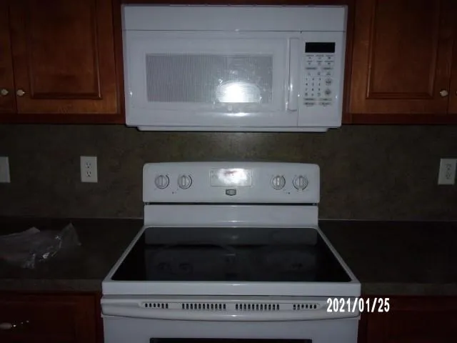 a stove top oven sitting inside of a kitchen