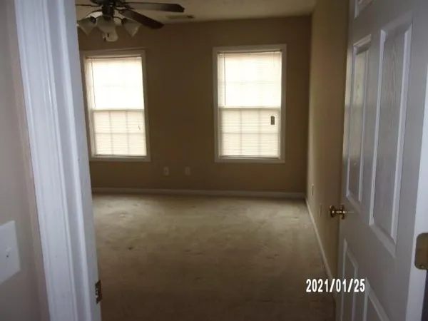 a view of an empty room and a window