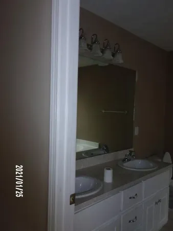 a bathroom with a sink and vanity