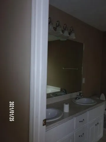 a bathroom with a sink and vanity