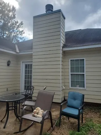 a backyard of a house with outdoor seating