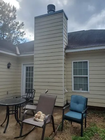 a backyard of a house with outdoor seating