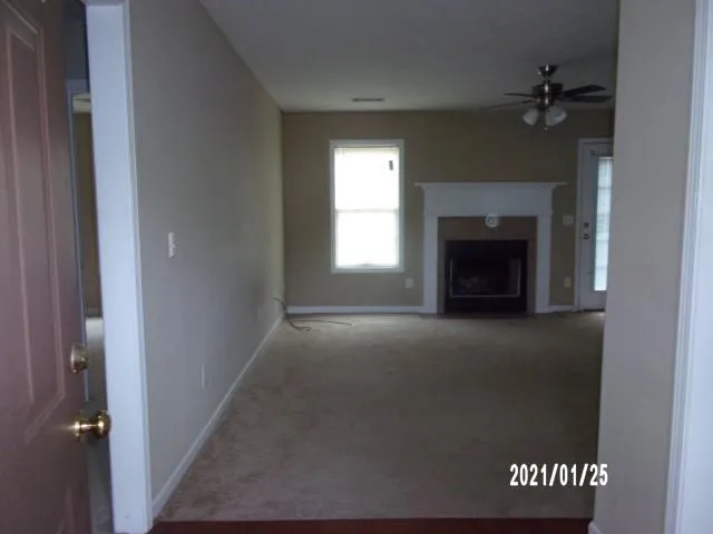 a view of empty room with a fireplace