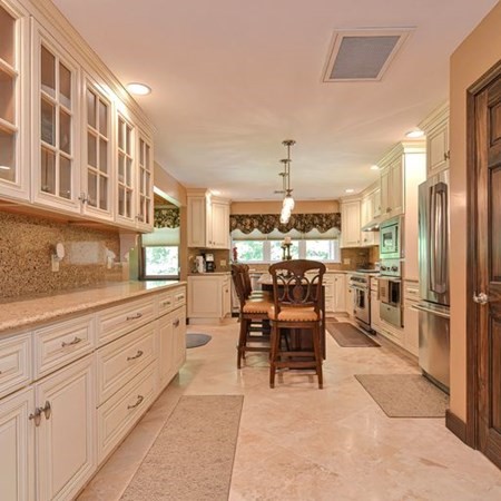48 Devol Pond Drive Westport, MA 02790 - Photo 13 of 39 a kitchen with stainless steel appliances kitchen island granite countertop a refrigerator and cabinets