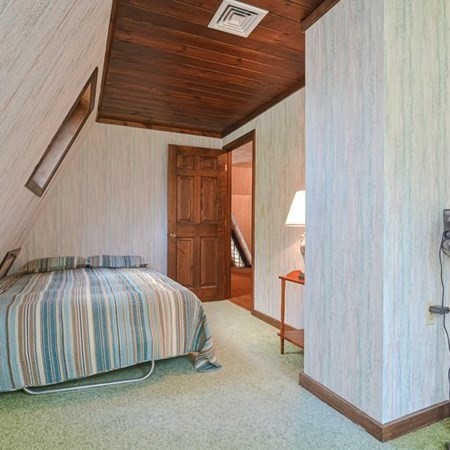48 Devol Pond Drive Westport, MA 02790 - Photo 28 of 39 a bedroom with a bed and a table