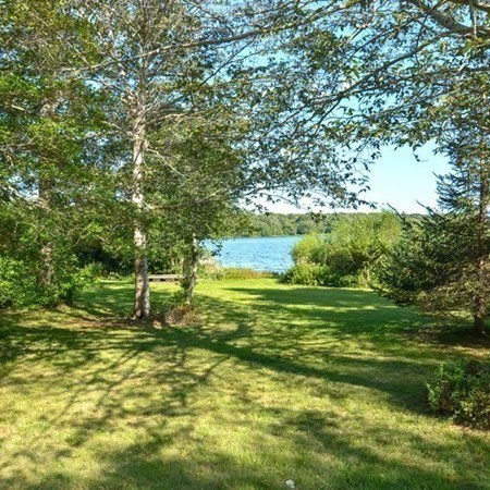 48 Devol Pond Drive Westport, MA 02790 - Photo 38 of 39 a view of a big yard with potted plants and large trees