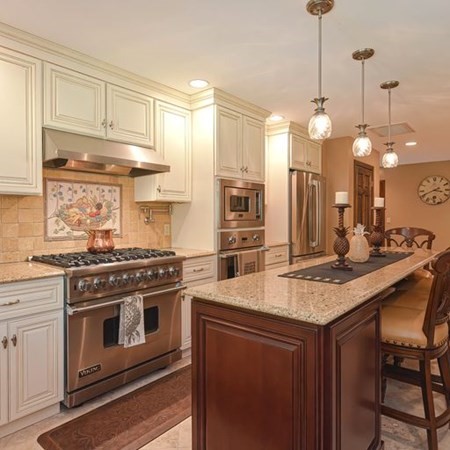 48 Devol Pond Drive Westport, MA 02790 - Photo 9 of 39 a kitchen with stainless steel appliances granite countertop a stove a sink a refrigerator and a wooden cabinets