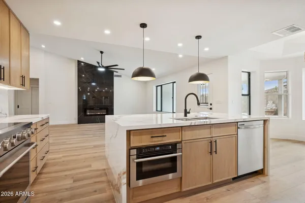 a kitchen with a sink stove and refrigerator