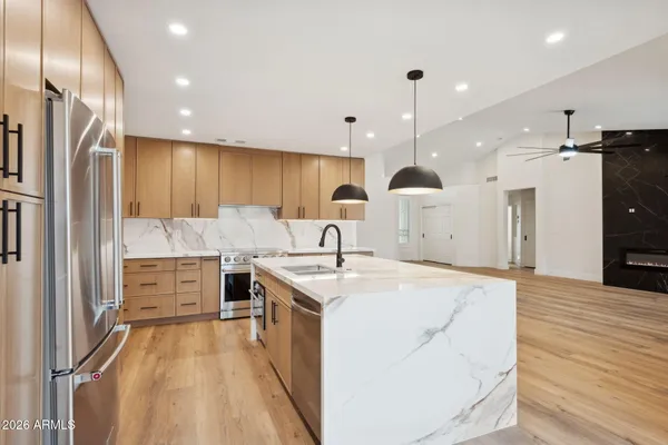 a kitchen with stainless steel appliances a refrigerator and a sink