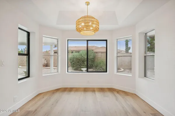a kitchen with granite countertop cabinets stainless steel appliances and wooden floor