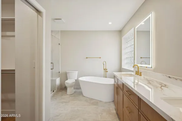 a bathroom with double vanity sinks and a mirror