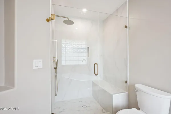 a view of a big room with wooden floor and windows