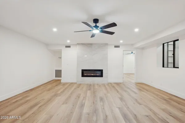 a bathroom with a granite countertop bathtub shower sink vanity and toilet