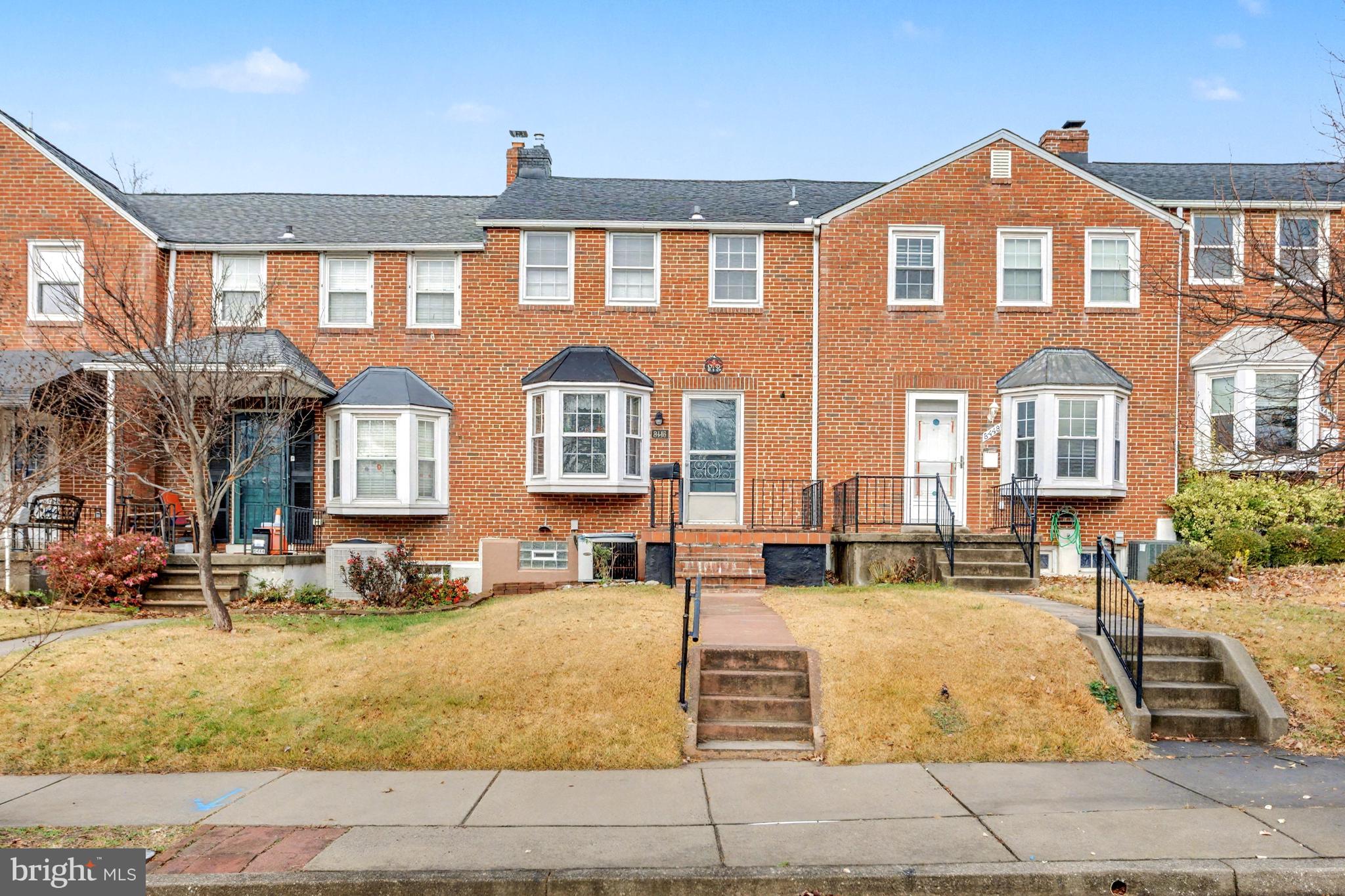 8446 Loch Raven Boulevard Baltimore, MD 21286 - Photo 1 of 30 a front view of a residential apartment building with a yard