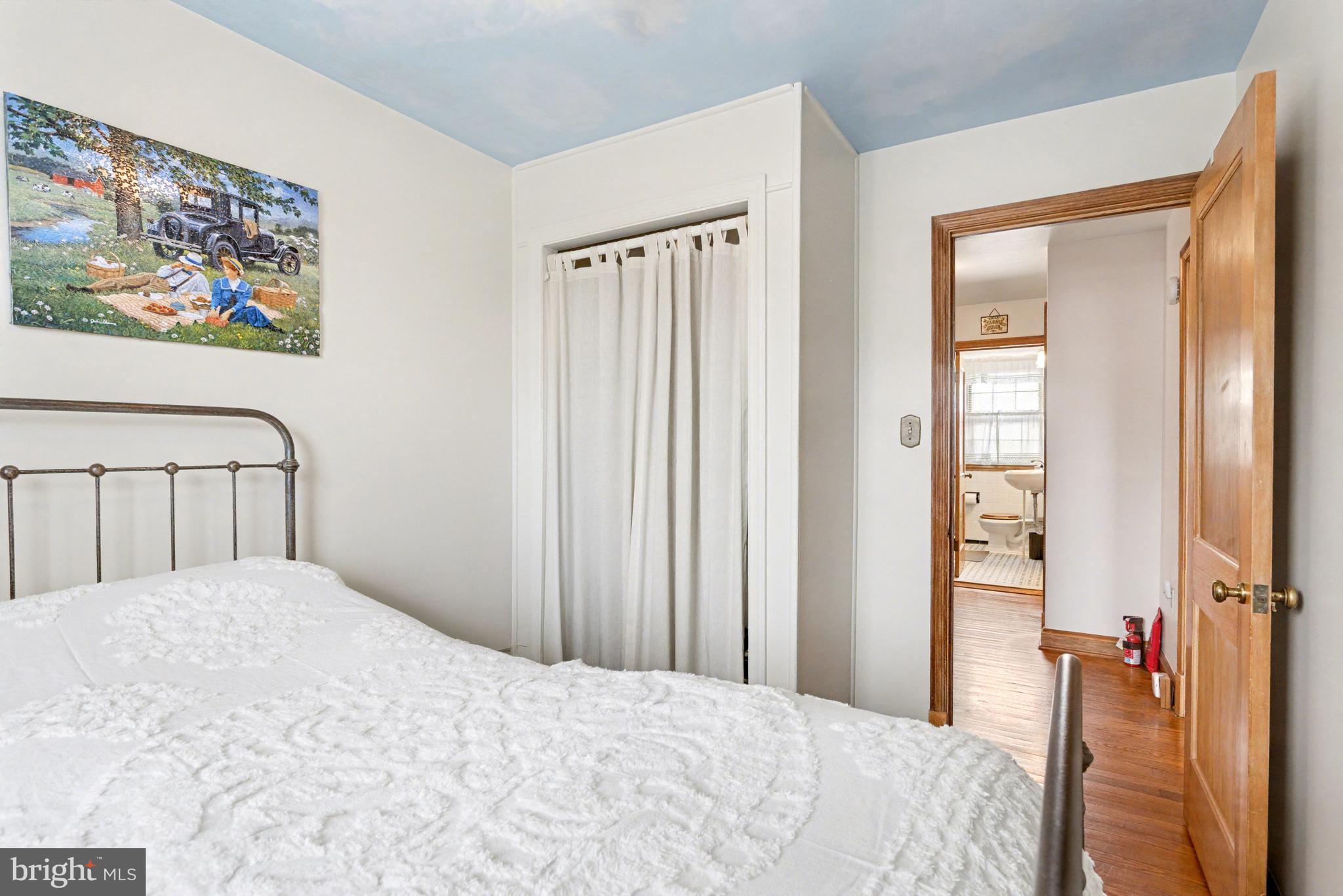 8446 Loch Raven Boulevard Baltimore, MD 21286 - Photo 15 of 30 a bedroom with a bed and a painting on the wall