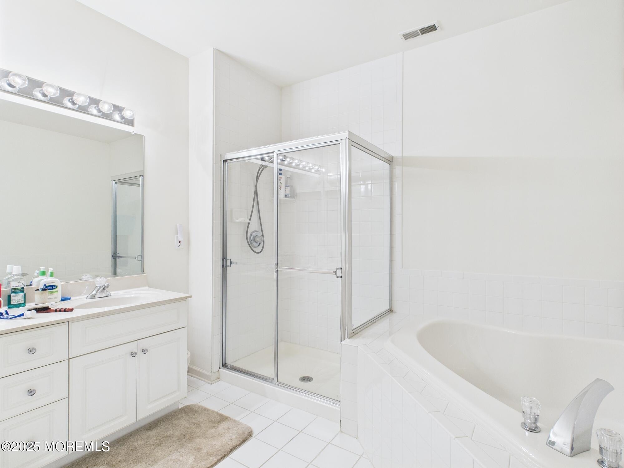 10 Windward Way Red Bank, NJ 07701 - Photo 14 of 31 a spacious bathroom with a double vanity sink a mirror and a bathtub