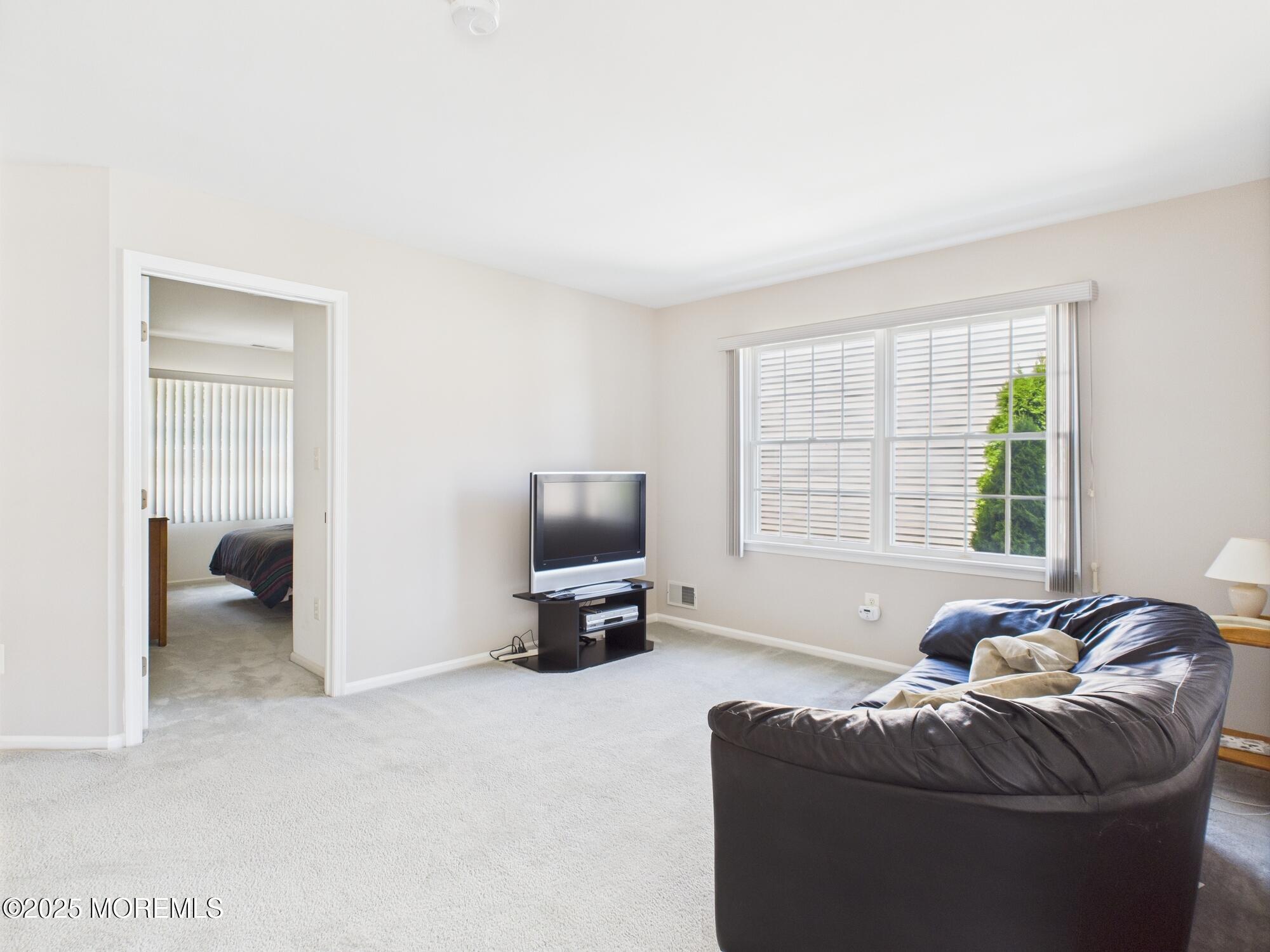 10 Windward Way Red Bank, NJ 07701 - Photo 18 of 31 a living room with furniture and a flat screen tv